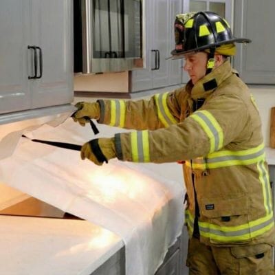 Wamoma Fire Blanket smothering a stovetop fire